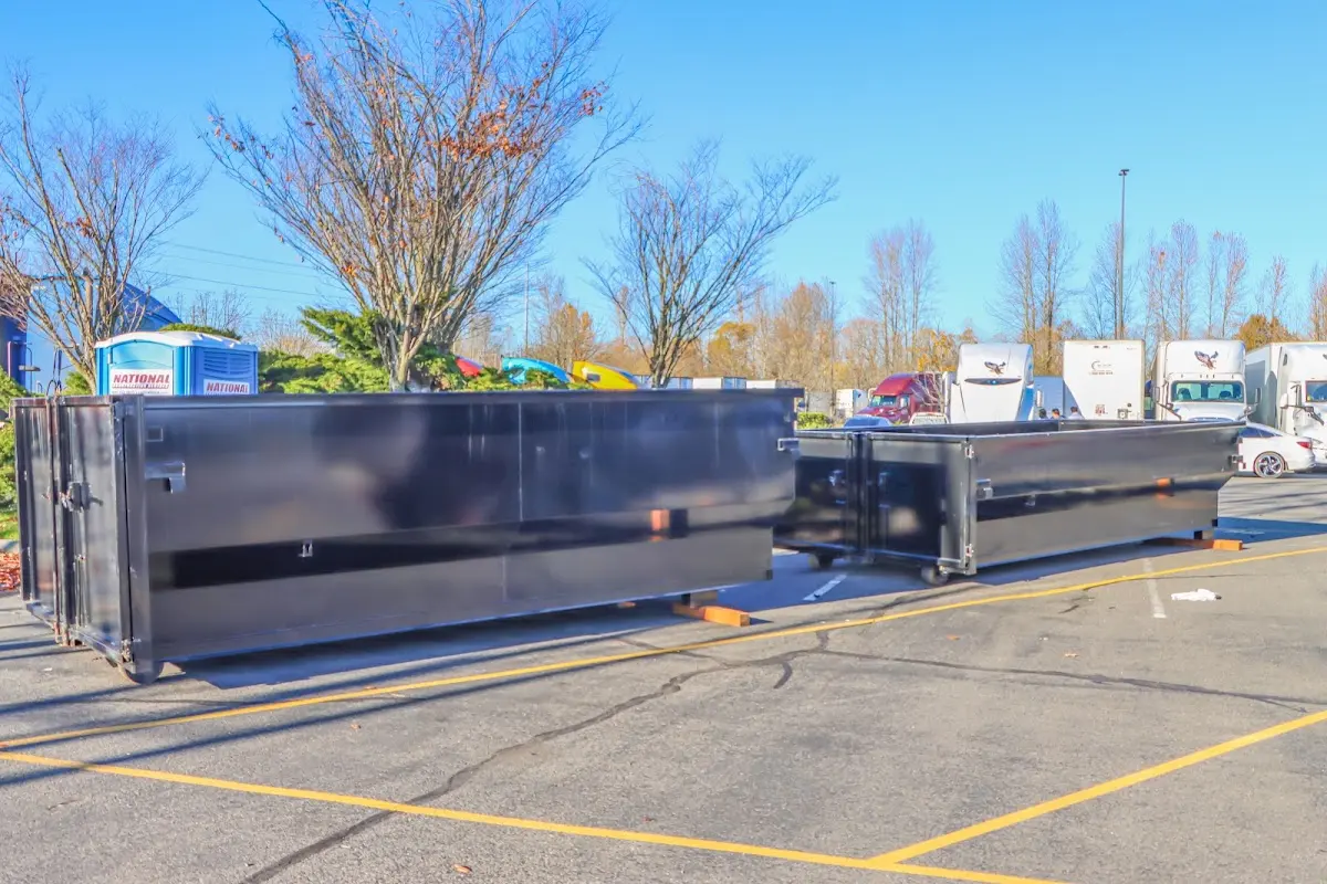 Professional dumpster rental service with roll-off container on residential driveway in Opa-locka